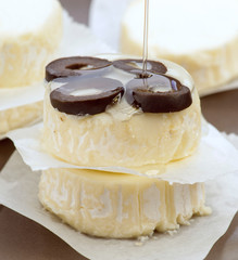 oil jet falls on portions of cheese with olives