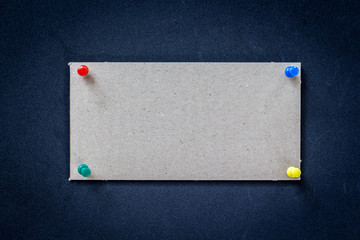 Paper with sticky note pinned on black backgrounds