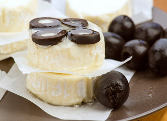 oil jet falls on portions of cheese with olives