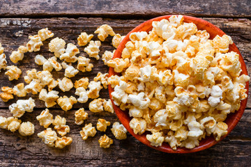 popcorn with caramel on a wooden background