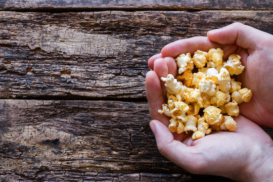 Man Holding A Handful Of Popcorn