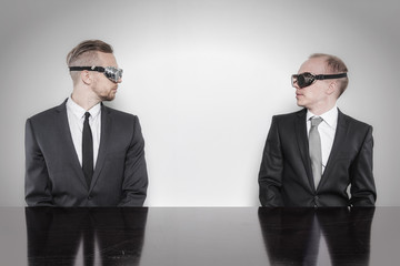Two businessman sitting at office desk