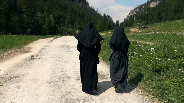 Nuns hiking in mountains, super slow motion 240fps
