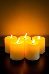 closeup to burning candles in darkness