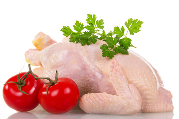 Whole raw chicken, tomatoes and parsley isolated on white.
