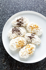 mini pavlova meringue cakes with chocolate chips and nuts.