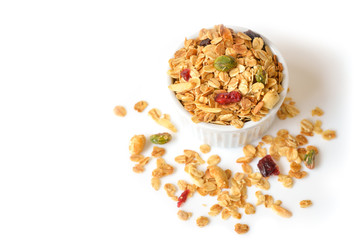 Homemade granola with honey, oatmeal, nuts raisin and cranberry on white background
