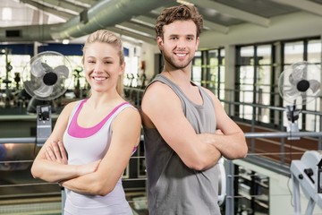 Fototapeta na wymiar Man and woman standing at gym