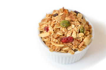 Homemade granola with honey, oatmeal, nuts raisin and cranberry on white background
