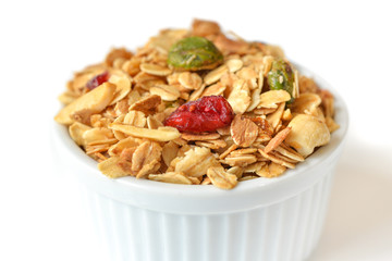Homemade granola with honey, oatmeal, nuts raisin and cranberry on white background
