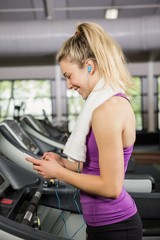 Woman listening to music on treadmill