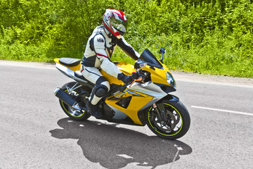 Obraz na płótnie Canvas motorcyclist biker fast riding