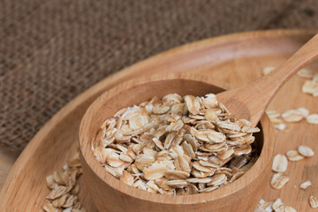 oats in bowl on wooden plate.