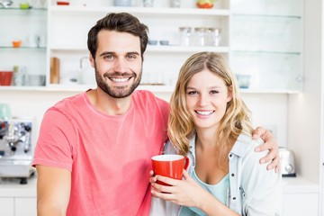 Young couple holding coffee mug