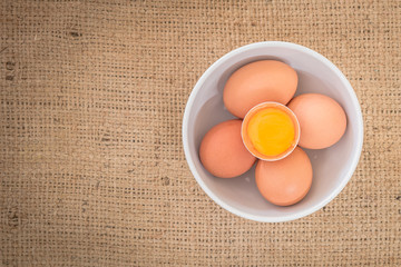 Fresh farm eggs. A egg yolk in cracked egg shell.