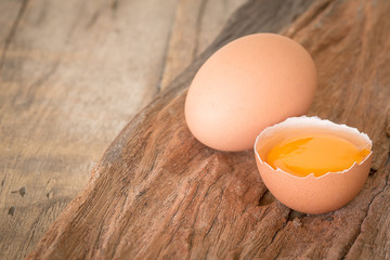 Fresh farm eggs. A egg yolk in cracked egg shell.