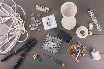 electrical tools and accessories on wooden table - obrazy, fototapety, plakaty