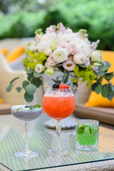 Glasses of cocktails on restaurant background