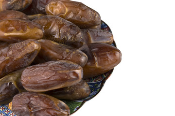 dried dates in the dish on white background