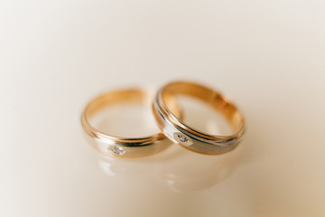 two gold wedding rings with stones