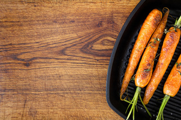 Roasted carrots on a black cast iron skillet