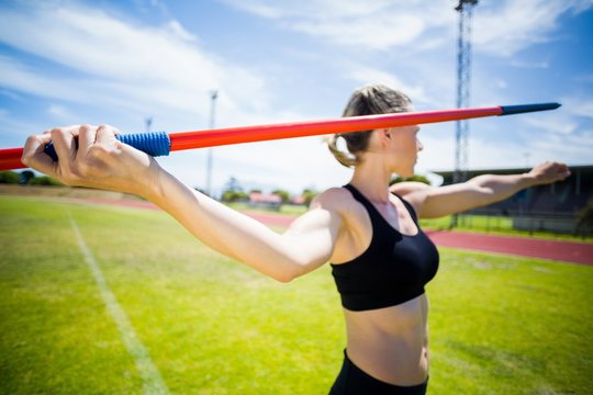 Female athlete about to throw a javelin