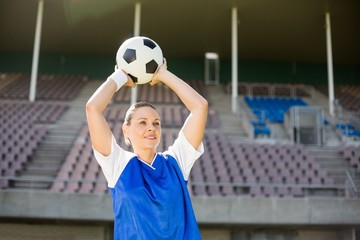 Female football player about to throw a football