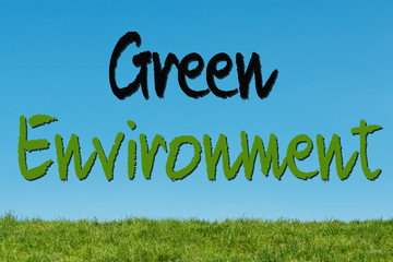 Green Environment concept text on a natural background with green grass and blue skye