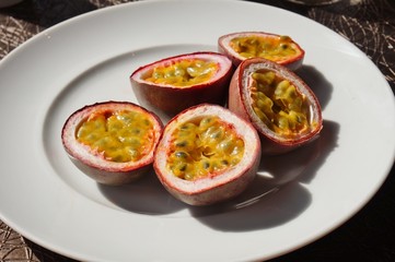 A plate of juicy passion fruit cut in half