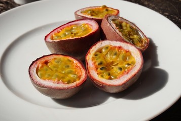 A plate of juicy passion fruit cut in half