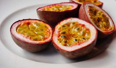 A plate of juicy passion fruit cut in half