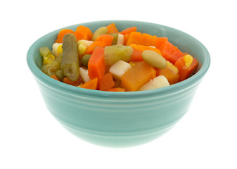 Mixed vegetables in a small bowl isolated on a small background.