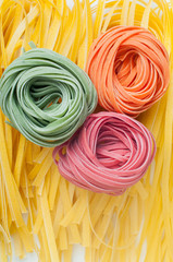 Three pieces of colorful raw italian pasta
