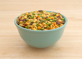 Minestrone soup mix in a bowl on a wood table