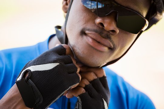 Athlete Putting On Cycling Helmet