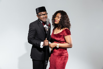 Couple singing into vintage microphone