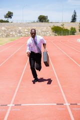 Obraz premium Businessman running on a running track
