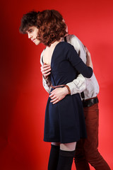 Portrait of a beautiful young couple love romance red background