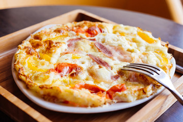 Scrambled eggs with bacon and tomato. Bon Appetit