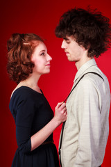 Portrait of a beautiful young couple love romance red background