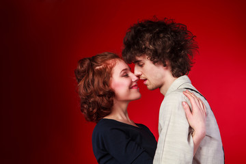 Portrait of a beautiful young couple love romance red background