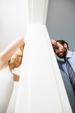 Upset Couple Standing On Opposite Sides Of The Wall