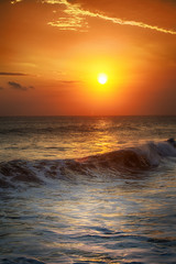 Sunrise in the sea with soft wave and cloudy