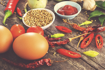 cooking concept, fresh kitchen herbs and spices on wooden table. top view and vintage tone [over light]