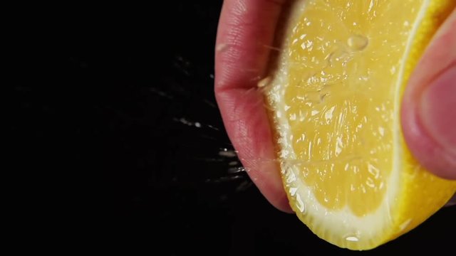 SLOW MOTION: A drops splash from a lemon