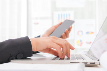 Closeup of business woman hand typing on laptop keyboard with  m