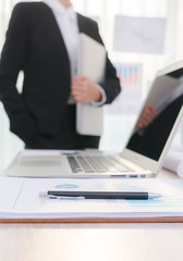Business people using laptop  and Financial charts  at meeting o