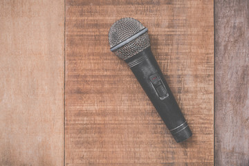 grunge microphone on wooden background
