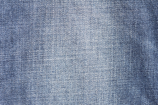 Closeup denim jeans texture. Stitched textured blue jeans denim fabric background. Old grunge vintage denim jeans.