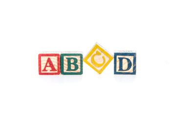 photo of a alphabet blocks spelling ABCD isolate on white backgr